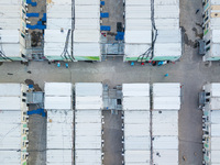  A drone view of the Tsing YI Community Isolation Facility, with staff in blue PPE sitting between the isolation blocks, in Hong Kong, China...