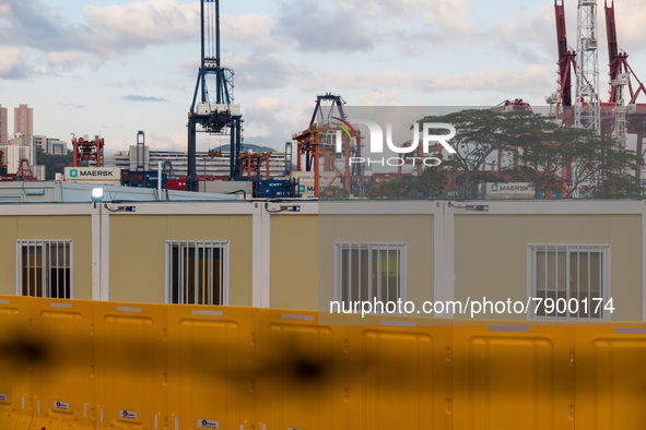  Prefabricated cabins hosting COVID patients can be seen with a background of a container port at the Tsing Yi Community Isolation Facility,...