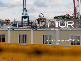  Prefabricated cabins hosting COVID patients can be seen with a background of a container port at the Tsing Yi Community Isolation Facility,...