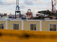  Prefabricated cabins hosting COVID patients can be seen with a background of a container port at the Tsing Yi Community Isolation Facility,...