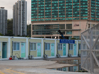  Prefabricated cabins can be seen at the Tsing Yi Community Isolation Facility in front of the Rambler hotel in the background, in Hong Kong...