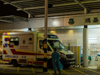 A paramedic in PPE waits for an ambulance near a makeshift triage area at Princess Margaret hospital, in Hong Kong, China, on March 16, 2022...