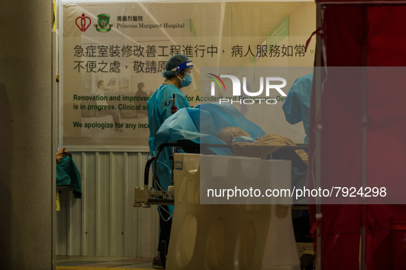 Nurses in PPE assist patients in a makeshift triage area at Princess Margaret Hospital, in Hong Kong, China, on March 16, 2022, in Hong Kong...