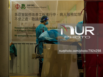 Nurses in PPE assist patients in a makeshift triage area at Princess Margaret Hospital, in Hong Kong, China, on March 16, 2022, in Hong Kong...