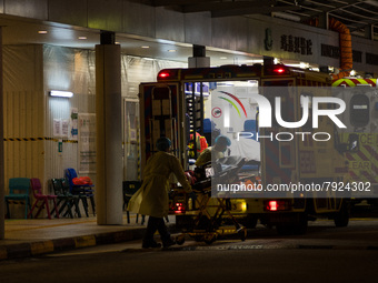 Paramedics load back their stretcher in the ambulance after having brought a patient at the Accident & Emergency ward of Princess Margaret h...