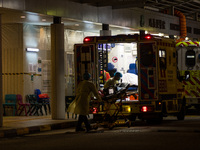 Paramedics load back their stretcher in the ambulance after having brought a patient at the Accident & Emergency ward of Princess Margaret h...