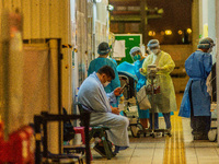 Nurses assist patients in an outdoor triage area at the Accident & Emergency ward of Princess Margaret hospital , in Hong Kong, China, on Ma...