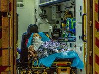 An elderly patient await in an ambulance to be carried to the Accident & Emergency ward of Princess Margaret ward, in Hong Kong, China, on M...