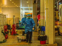 Paramedics bring a hospital bed to transfer an elderly patient to the Accident & Emergency ward of Princess Margaret hospital, in Hong Kong,...