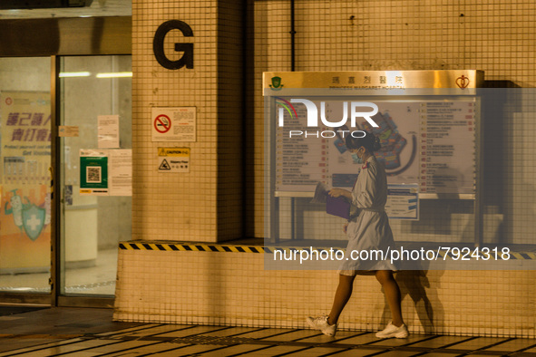 A nurse walks outside Princess Margaret hospital, in Hong Kong, China, on March 16, 2022, in Hong Kong, China, on March 16, 2022.   