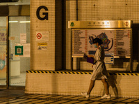 A nurse walks outside Princess Margaret hospital, in Hong Kong, China, on March 16, 2022, in Hong Kong, China, on March 16, 2022.   (