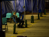 A lonely patient is seated in a triage area for COVID patients at Caritas Medical Centre, in Hong Kong, China, on March 16, 2022, in Hong Ko...