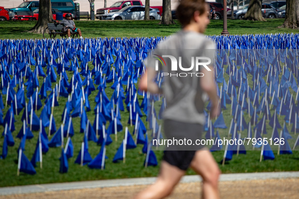 Blue flags are seen on the National Mall in Washington, D.C. on March 18, 2022 as part of the United In Blue art installation. The installat...