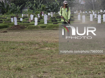 Officers clean the COVID-19 graveyard in Srengsesngsawah, South Jakata, Jakarta, Indonesia. Towards Ramadan, officers clean the graves, so t...