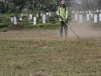 Officers clean the COVID-19 graveyard in Srengsesngsawah, South Jakata, Jakarta, Indonesia. Towards Ramadan, officers clean the graves, so t...