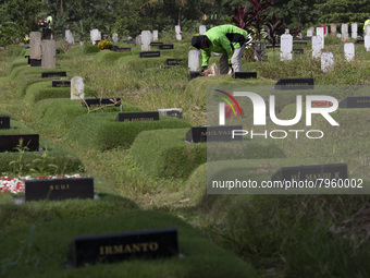 Officers clean the COVID-19 graveyard in Srengsesngsawah, South Jakata, Jakarta, Indonesia. Towards Ramadan, officers clean the graves, so t...