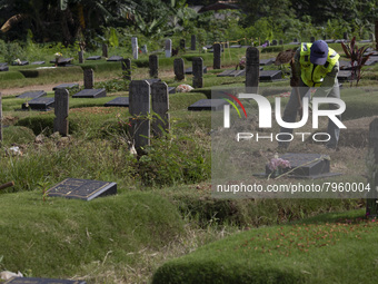 Officers clean the COVID-19 graveyard in Srengsesngsawah, South Jakata, Jakarta, Indonesia. Towards Ramadan, officers clean the graves, so t...