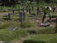 Officers clean the COVID-19 graveyard in Srengsesngsawah, South Jakata, Jakarta, Indonesia. Towards Ramadan, officers clean the graves, so t...