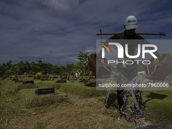 Officers clean the COVID-19 graveyard in Srengsesngsawah, South Jakata, Jakarta, Indonesia. Towards Ramadan, officers clean the graves, so t...