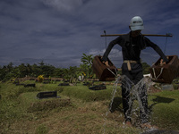 Officers clean the COVID-19 graveyard in Srengsesngsawah, South Jakata, Jakarta, Indonesia. Towards Ramadan, officers clean the graves, so t...