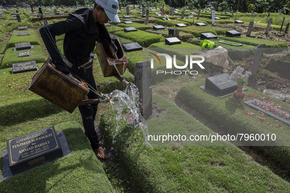 Officers clean the COVID-19 graveyard in Srengsesngsawah, South Jakata, Jakarta, Indonesia. Towards Ramadan, officers clean the graves, so t...