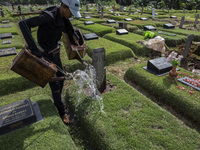 Officers clean the COVID-19 graveyard in Srengsesngsawah, South Jakata, Jakarta, Indonesia. Towards Ramadan, officers clean the graves, so t...