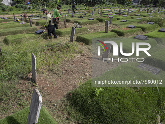 Officers clean the COVID-19 graveyard in Srengsesngsawah, South Jakata, Jakarta, Indonesia. Towards Ramadan, officers clean the graves, so t...