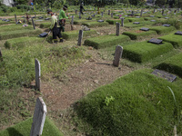 Officers clean the COVID-19 graveyard in Srengsesngsawah, South Jakata, Jakarta, Indonesia. Towards Ramadan, officers clean the graves, so t...