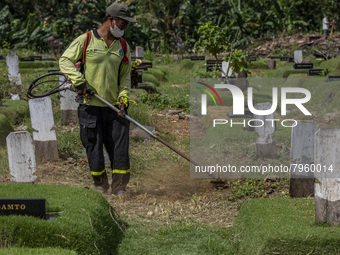 Officers clean the COVID-19 graveyard in Srengsesngsawah, South Jakata, Jakarta, Indonesia. Towards Ramadan, officers clean the graves, so t...