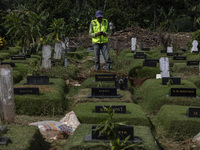 Officers clean the COVID-19 graveyard in Srengsesngsawah, South Jakata, Jakarta, Indonesia. Towards Ramadan, officers clean the graves, so t...