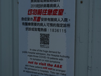 A poster warns asymptomatic or mild symptoms COVID patients not to come to the hospital at United Christian Hospital, in Hong Kong, China, o...