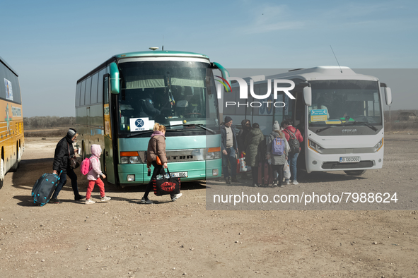 Ukrainian citizens are seen getting the bus headed to Bucarest, Romania, at the transit point for refugees in Palanca, south Moldova, on 202...