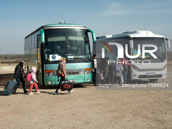 Ukrainian citizens are seen getting the bus headed to Bucarest, Romania, at the transit point for refugees in Palanca, south Moldova, on 202...