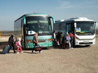 Ukrainian citizens are seen getting the bus headed to Bucarest, Romania, at the transit point for refugees in Palanca, south Moldova, on 202...