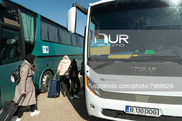 Ukrainian citizens are seen getting the bus headed to Bucarest, Romania, at the transit point for refugees in Palanca, south Moldova, on 202...