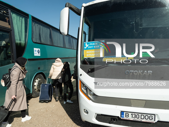 Ukrainian citizens are seen getting the bus headed to Bucarest, Romania, at the transit point for refugees in Palanca, south Moldova, on 202...