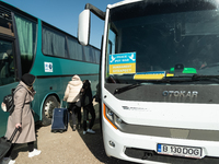 Ukrainian citizens are seen getting the bus headed to Bucarest, Romania, at the transit point for refugees in Palanca, south Moldova, on 202...