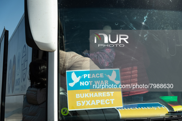 Ukrainian citizens are seen getting the bus headed to Bucarest, Romania, at the transit point for refugees in Palanca, south Moldova, on 202...