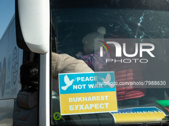 Ukrainian citizens are seen getting the bus headed to Bucarest, Romania, at the transit point for refugees in Palanca, south Moldova, on 202...