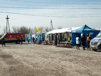 Humanitarian team members are seen at the transit point for refugees in Palanca, south Moldova, on 2022-03-27. (