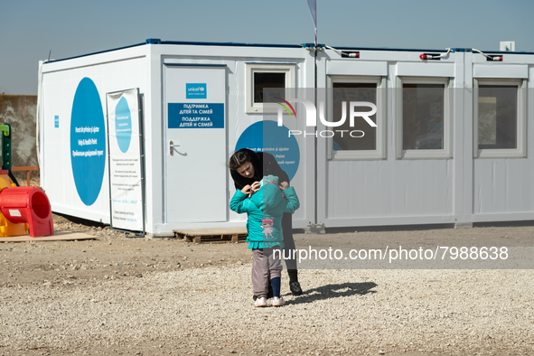 Ukrainian mother and her child are seen in front of the UNICEF Blue Point at the transit point for refugees in Palanca, south Moldova, on 20...