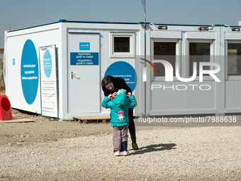 Ukrainian mother and her child are seen in front of the UNICEF Blue Point at the transit point for refugees in Palanca, south Moldova, on 20...