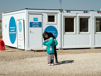 Ukrainian mother and her child are seen in front of the UNICEF Blue Point at the transit point for refugees in Palanca, south Moldova, on 20...