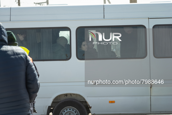 Ukrainian citizens are seen through the screens of a mini bus, at the transit point for refugees in Palanca, south Moldova, on 2022-03-27. 