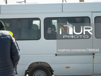 Ukrainian citizens are seen through the screens of a mini bus, at the transit point for refugees in Palanca, south Moldova, on 2022-03-27. (