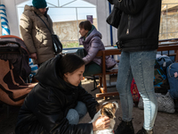 Ukrainian citizens are seen resting inside a tent, at the transit point for refugees in Palanca, south Moldova, on 2022-03-27. (