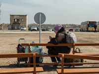 An Ukrainian woman is seen waiting for the transport to Romania at the transit point for refugees in Palanca, south Moldova, on 2022-03-27....