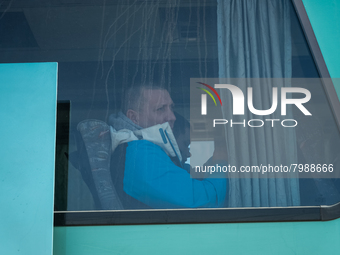 Ukrainian citizens are seen through the screen of a bus headed to Bucarest, Romania, at the transit point for refugees in Palanca, south Mol...