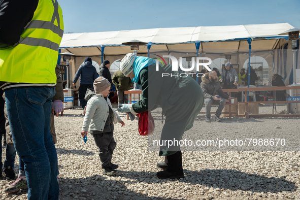 An Ukrainian grandmother and her grandson just arrived from the border are seen at the transit point for refugees in Palanca, south Moldova,...