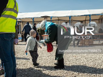 An Ukrainian grandmother and her grandson just arrived from the border are seen at the transit point for refugees in Palanca, south Moldova,...